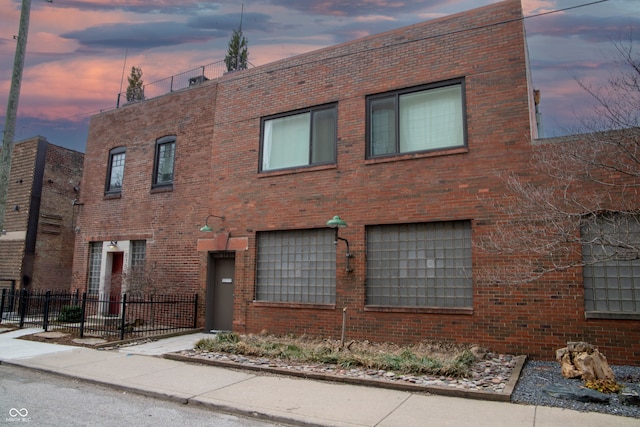 view of outdoor building at dusk