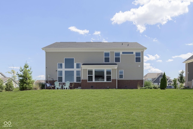 rear view of house with a yard