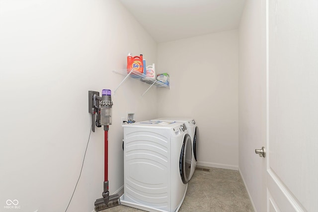 clothes washing area with washing machine and clothes dryer