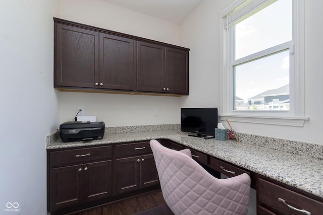 office space with built in desk, plenty of natural light, and dark wood-type flooring