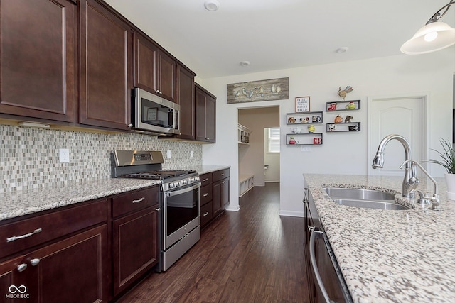 kitchen featuring sink, stainless steel appliances, light stone counters, dark hardwood / wood-style flooring, and decorative backsplash