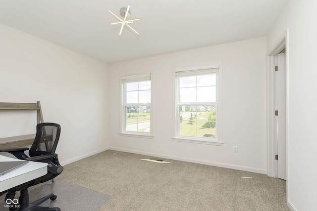 office area with light colored carpet and an inviting chandelier