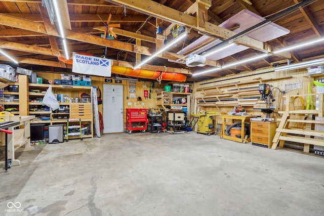 garage with a workshop area and a garage door opener