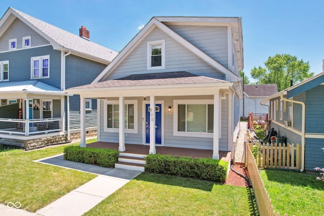 view of front facade featuring covered porch and a front yard