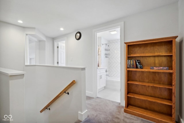 hallway with light colored carpet