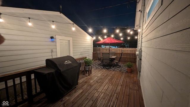 deck at twilight featuring area for grilling