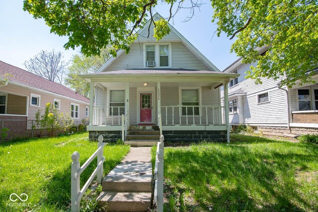 bungalow-style home featuring a front lawn and a porch