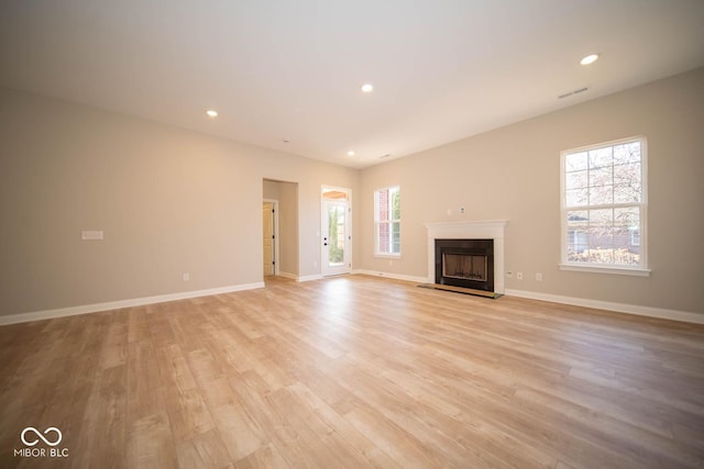 7936 Beaumont Green Pl, Indianapolis, IN 46250 - unfurnished living room featuring light wood-type flooring, a fireplace, and recessed lighting