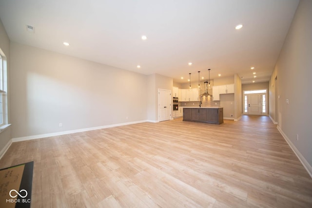 unfurnished living room with light wood-type flooring