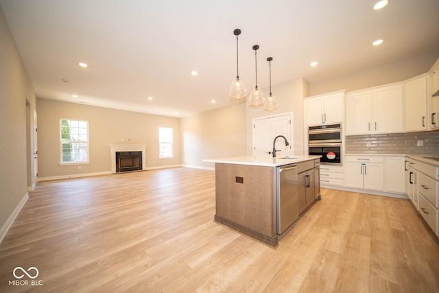7936 Beaumont Green Pl, Indianapolis, IN 46250 - kitchen with appliances with stainless steel finishes, recessed lighting, decorative backsplash, white cabinetry, and light wood-type flooring