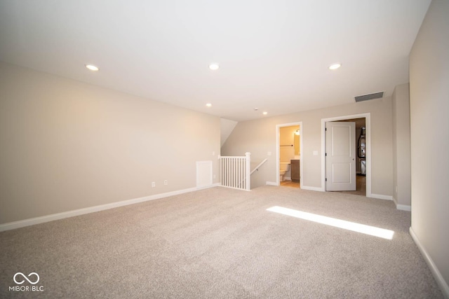 empty room featuring lofted ceiling and light carpet