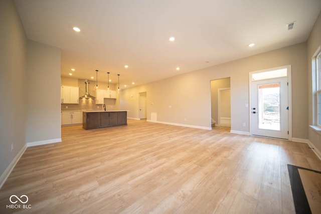 unfurnished living room featuring light hardwood / wood-style floors