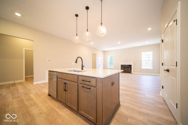7936 Beaumont Green Pl, Indianapolis, IN 46250 - kitchen with stainless steel dishwasher, light wood-type flooring, a kitchen island with sink, pendant lighting, and recessed lighting