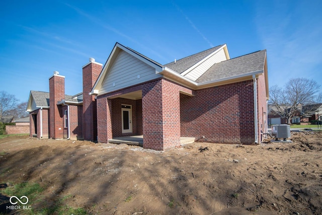 exterior space with central AC unit and a patio area