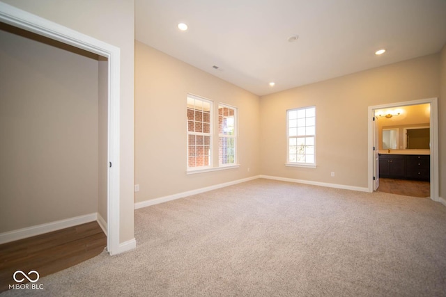 unfurnished bedroom featuring carpet flooring and connected bathroom