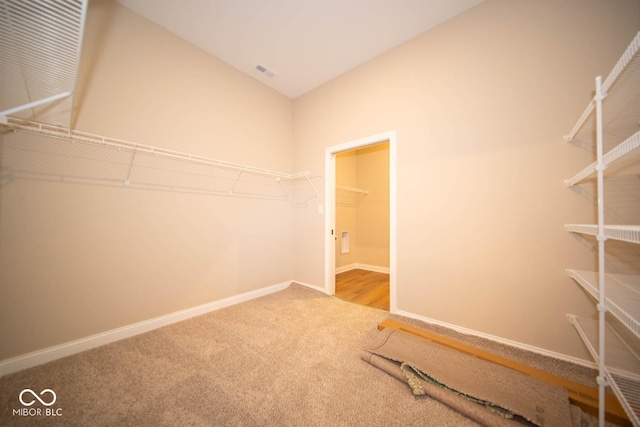 walk in closet with carpet floors