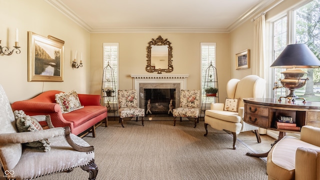 living area featuring crown molding, plenty of natural light, and a fireplace