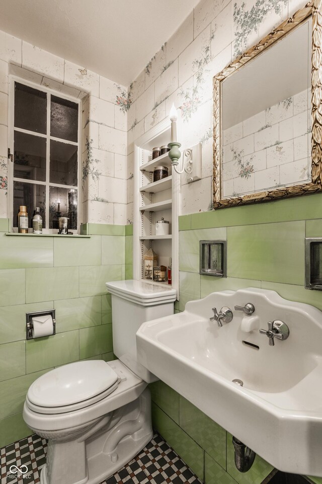 bathroom featuring tile patterned flooring, sink, and toilet