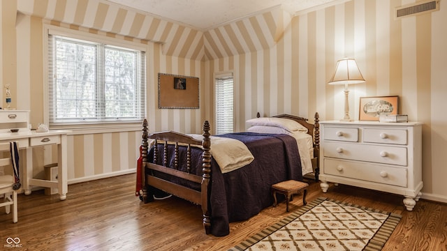 bedroom with hardwood / wood-style floors and a textured ceiling