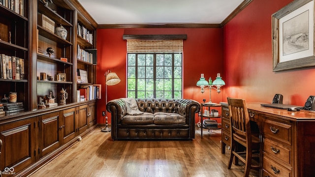 living area featuring ornamental molding and light hardwood / wood-style floors