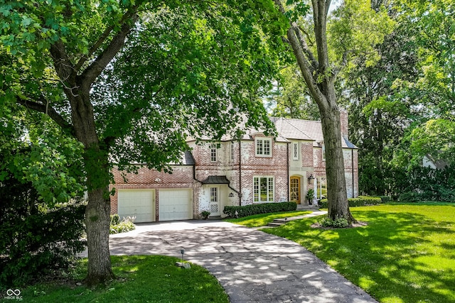 view of front of house with a garage and a front yard