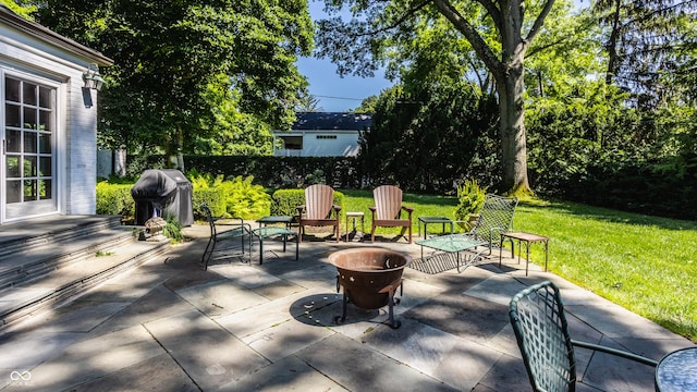 view of patio / terrace featuring a grill and a fire pit