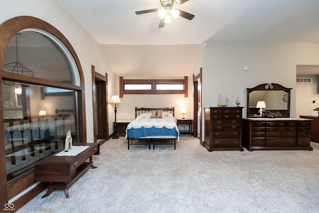 bedroom with ceiling fan, light carpet, and vaulted ceiling