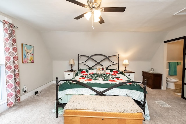 carpeted bedroom featuring ensuite bath, ceiling fan, and vaulted ceiling