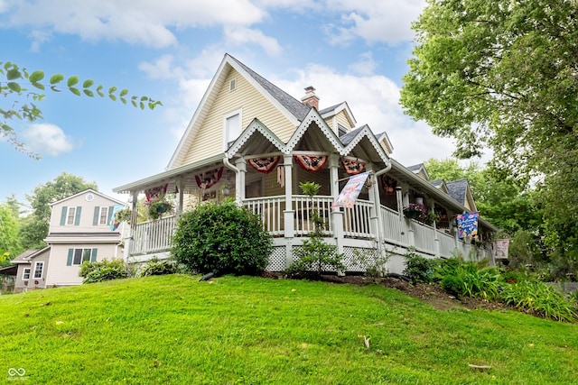 view of front of home with a porch and a front yard