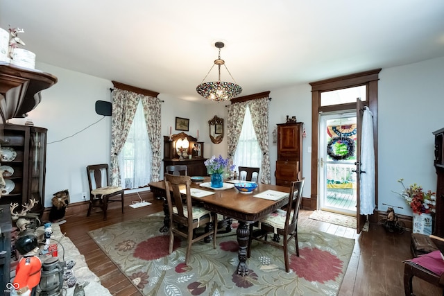 dining space with dark hardwood / wood-style flooring