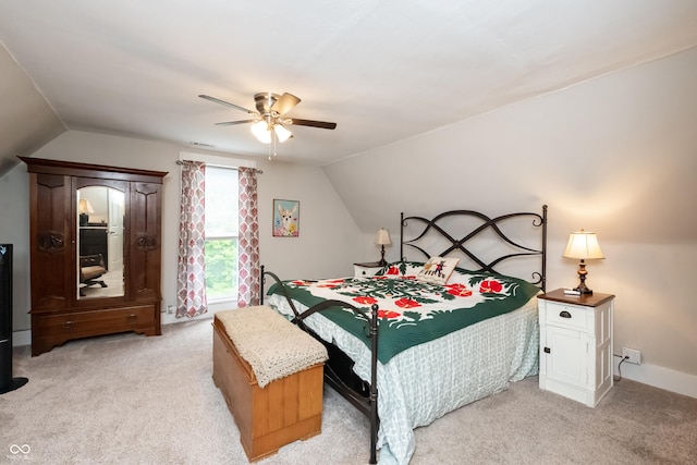 carpeted bedroom with vaulted ceiling and ceiling fan