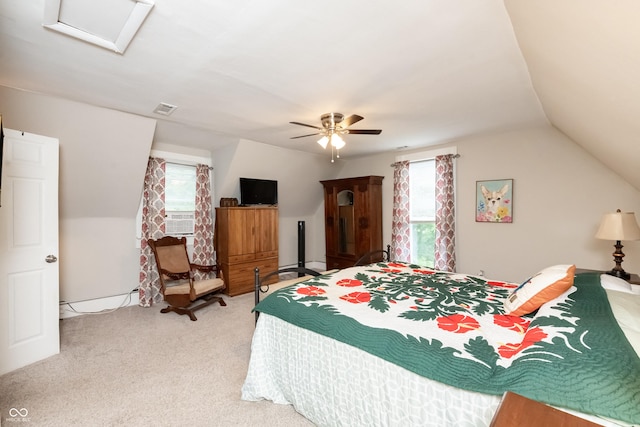 bedroom with carpet, ceiling fan, vaulted ceiling, and multiple windows