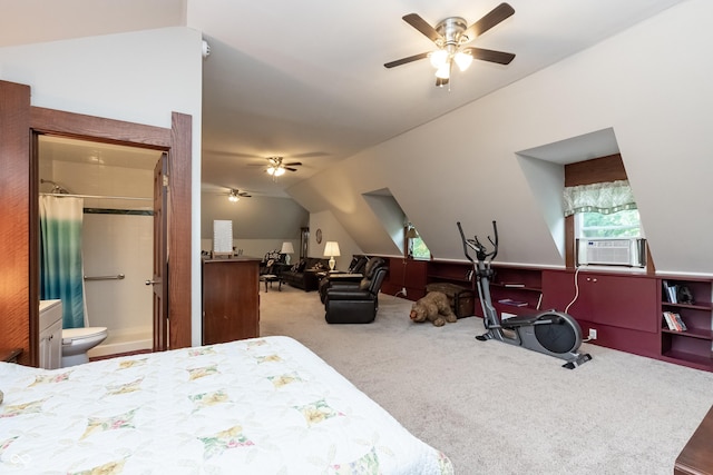 carpeted bedroom featuring vaulted ceiling, ensuite bath, ceiling fan, and cooling unit