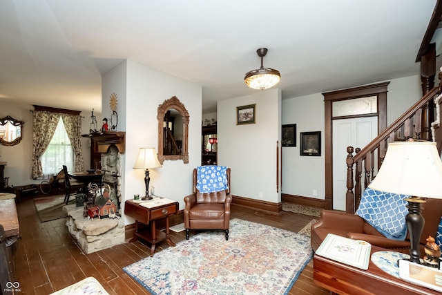 sitting room with dark wood-type flooring