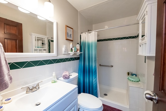 bathroom with a shower with shower curtain, vanity, toilet, and tile walls