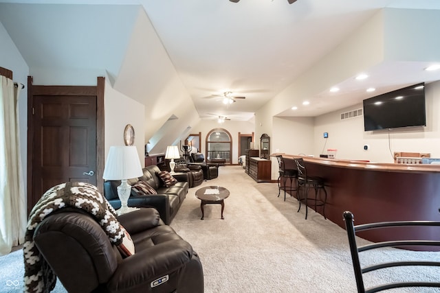 carpeted living room with indoor bar, ceiling fan, and lofted ceiling