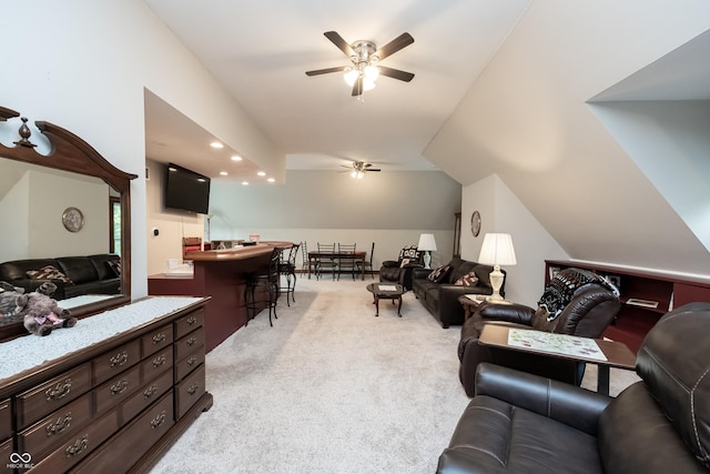 living room with light carpet, ceiling fan, and lofted ceiling