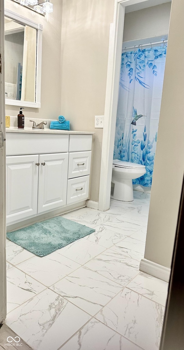 bathroom featuring vanity, curtained shower, and toilet