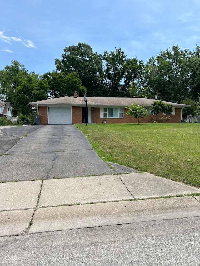 single story home featuring a front lawn and a garage