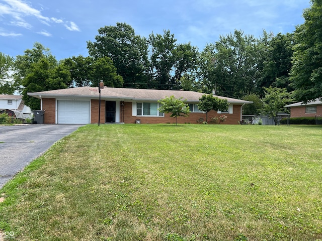 single story home with a garage and a front lawn