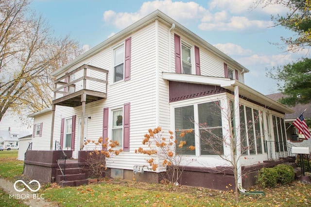 1104 W Main St, Crawfordsville, IN 47933 - rear view of house featuring a balcony and a sunroom