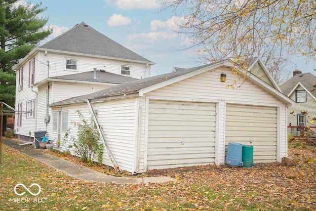 1104 W Main St, Crawfordsville, IN 47933 - view of property exterior featuring an outbuilding and roof with shingles
