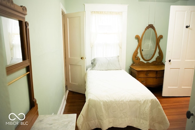 bedroom with dark hardwood / wood-style flooring