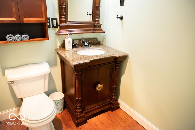 bathroom featuring vanity, hardwood / wood-style flooring, and toilet