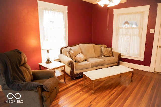 living room featuring hardwood / wood-style flooring and ceiling fan