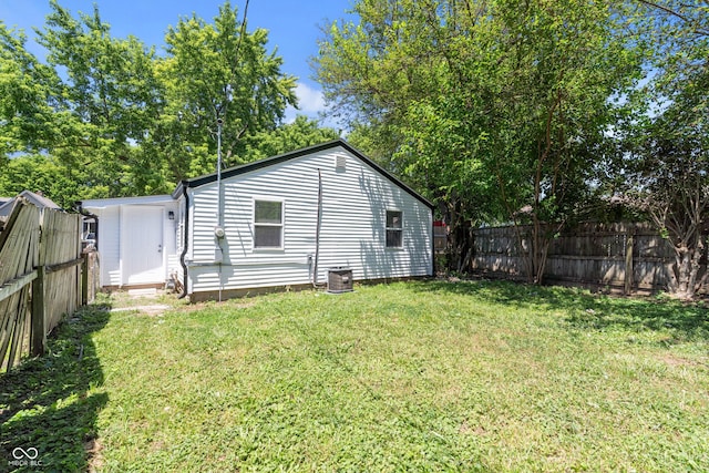 929 Olin Ave, Indianapolis, IN 46222 - rear view of house featuring central air condition unit and a lawn