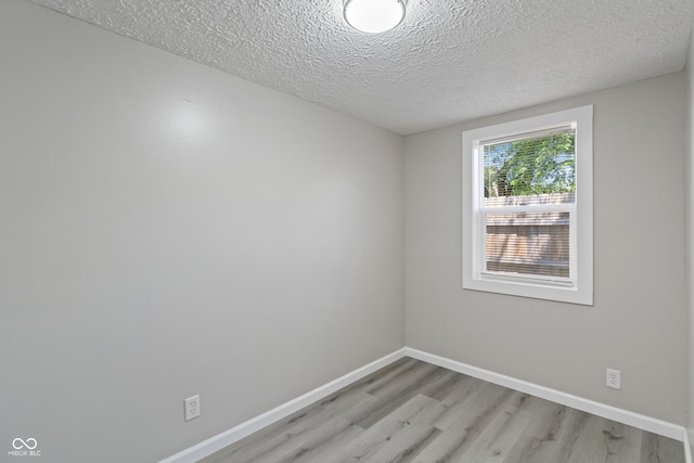 929 Olin Ave, Indianapolis, IN 46222 - spare room featuring a textured ceiling and light hardwood / wood-style floors