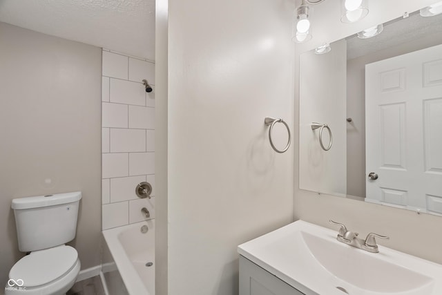 929 Olin Ave, Indianapolis, IN 46222 - full bathroom featuring tiled shower / bath, vanity, a textured ceiling, and toilet