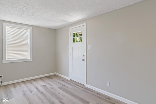 929 Olin Ave, Indianapolis, IN 46222 - foyer entrance with light hardwood / wood-style flooring and a textured ceiling