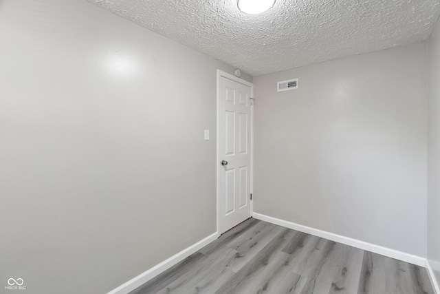929 Olin Ave, Indianapolis, IN 46222 - unfurnished room featuring a textured ceiling and light wood-type flooring